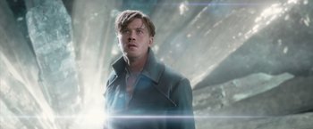 Movie still from “Pan” (2015), directed by Joe Wright – A man in a blue jacket is standing in front of a wall; Close Up shot, Low angle