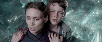 Movie still from “Pan” (2015), directed by Joe Wright – A woman and a boy are standing next to each other; Close Up shot, Overhead angle