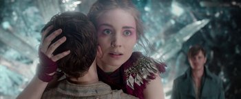 Movie still from “Pan” (2015), directed by Joe Wright – A young woman holding a young man's shoulder in front of a forest; Close Up shot, Over the shoulder angle