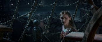 Movie still from “Pan” (2015), directed by Joe Wright – A woman standing in front of a rope bridge at night; Close Up shot, Over the shoulder angle