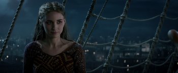 Movie still from “Pan” (2015), directed by Joe Wright – A woman standing on top of a boat at night; Close Up shot, Over the shoulder angle