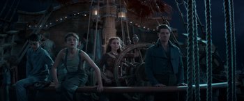 Movie still from “Pan” (2015), directed by Joe Wright – A group of people standing next to each other on top of a boat; Medium shot, Low angle