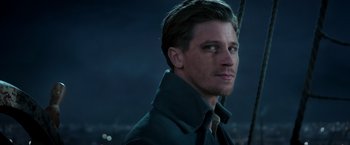 Movie still from “Pan” (2015), directed by Joe Wright – A person wearing a suit and tie; Close Up shot, Over the shoulder angle