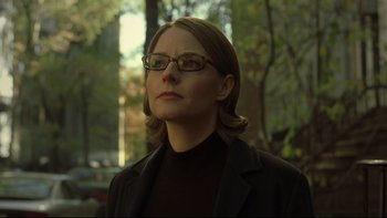 Movie still from “Panic Room” (2002), directed by David Fincher – A woman wearing glasses and a black jacket; Close Up shot, Low angle