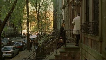 Movie still from “Panic Room” (2002), directed by David Fincher – A man and a woman walking down the steps of a building; Wide shot, High angle