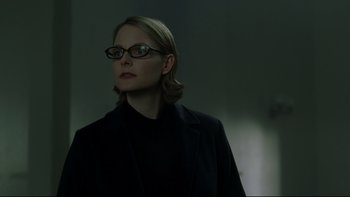 Movie still from “Panic Room” (2002), directed by David Fincher – A woman wearing glasses and a black jacket; Close Up shot, Low angle