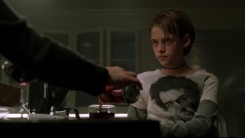 Movie still from “Panic Room” (2002), directed by David Fincher – A person pouring a drink into a glass; Medium shot, Over the shoulder angle