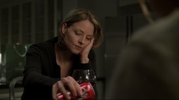 Movie still from “Panic Room” (2002), directed by David Fincher – A woman sitting at a table with a glass of red wine; Close Up shot, Over the shoulder angle