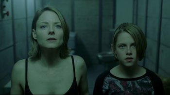 Movie still from “Panic Room” (2002), directed by David Fincher – Two women standing next to each other in a room; Medium shot, Low angle