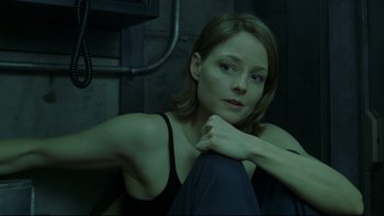 Movie still from “Panic Room” (2002), directed by David Fincher – A beautiful young woman sitting on top of a couch; Close Up shot, High angle