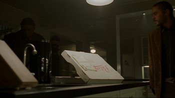 Movie still from “Panic Room” (2002), directed by David Fincher – A pizza box sitting on top of a counter; Medium shot, Low angle