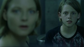 Movie still from “Panic Room” (2002), directed by David Fincher – Two young women are looking at the camera; Close Up shot, Over the shoulder angle