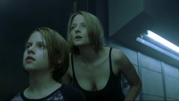 Movie still from “Panic Room” (2002), directed by David Fincher – A woman with long brown hair looking up at the ceiling; Close Up shot, Low angle