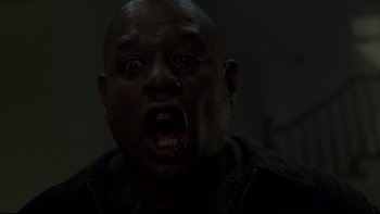 Movie still from “Panic Room” (2002), directed by David Fincher – A man with an open mouth in a dark room; Close Up shot, Low angle