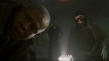 Movie still from “Panic Room” (2002), directed by David Fincher – A group of men standing next to each other in the dark; Close Up shot, Low angle