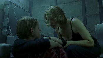 Movie still from “Panic Room” (2002), directed by David Fincher – Two women sitting on a bed in a dark room; Medium shot, Low angle