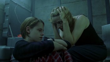 Movie still from “Panic Room” (2002), directed by David Fincher – Two women sitting next to each other in a room; Medium shot, Low angle