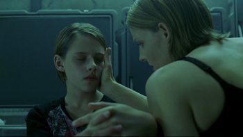 Movie still from “Panic Room” (2002), directed by David Fincher – A woman touching the face of a young boy; Close Up shot, Over the shoulder angle