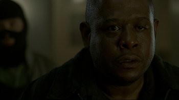 Movie still from “Panic Room” (2002), directed by David Fincher – A man's face in a dark room; Close Up shot, Low angle