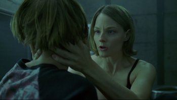 Movie still from “Panic Room” (2002), directed by David Fincher – A woman is looking at a man in the mirror; Close Up shot, Over the shoulder angle