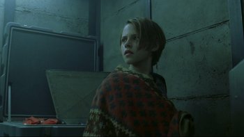 Movie still from “Panic Room” (2002), directed by David Fincher – A young girl is wrapped in a blanket in a dark room; Medium shot, Low angle