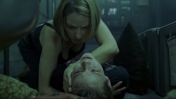 Movie still from “Panic Room” (2002), directed by David Fincher – A woman is holding on to a boy's head; Close Up shot, Over the shoulder angle
