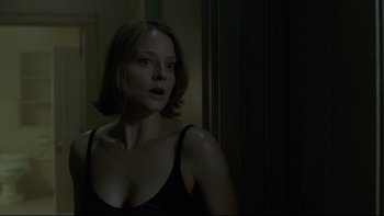 Movie still from “Panic Room” (2002), directed by David Fincher – A woman in a black tank top looking at the camera; Close Up shot, Over the shoulder angle