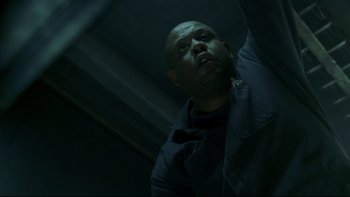 Movie still from “Panic Room” (2002), directed by David Fincher – A man standing in the dark looking up at the ceiling; Close Up shot, Low angle