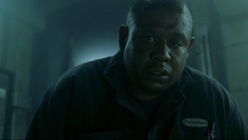 Movie still from “Panic Room” (2002), directed by David Fincher – A person wearing a black shirt; Close Up shot, Low angle