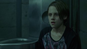 Movie still from “Panic Room” (2002), directed by David Fincher – A young girl is looking at the camera; Medium shot, Low angle