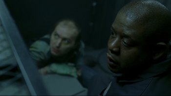 Movie still from “Panic Room” (2002), directed by David Fincher – Two men are sitting in a dark room; Close Up shot, Over the shoulder angle