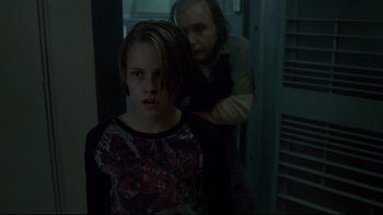 Movie still from “Panic Room” (2002), directed by David Fincher – A young girl standing next to an older woman; Medium shot, Over the shoulder angle