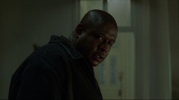 Movie still from “Panic Room” (2002), directed by David Fincher – A person in a dark room; Close Up shot, Low angle