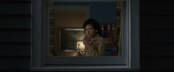 Movie still from “Paper Towns” (2015), directed by Jake Schreier – A young man holding a tooth brush in front of a bathroom mirror; Close Up shot, Over the shoulder angle