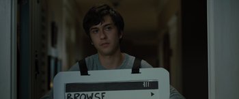 Movie still from “Paper Towns” (2015), directed by Jake Schreier – A young man holding a sign that says " browse "; Close Up shot, Over the shoulder angle