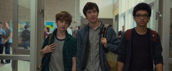 Movie still from “Paper Towns” (2015), directed by Jake Schreier – Two young men standing next to each other in a building; Medium shot, Over the shoulder angle