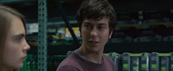 Movie still from “Paper Towns” (2015), directed by Jake Schreier – A young man is looking into the camera; Close Up shot, Over the shoulder angle