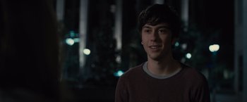 Movie still from “Paper Towns” (2015), directed by Jake Schreier – A young man is smiling for the camera; Close Up shot, Over the shoulder angle