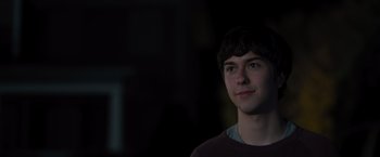Movie still from “Paper Towns” (2015), directed by Jake Schreier – A young man is standing in the dark; Close Up shot, Over the shoulder angle