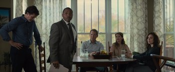 Movie still from “Paper Towns” (2015), directed by Jake Schreier – A man standing in front of two men sitting at a table; Medium shot, Over the shoulder angle