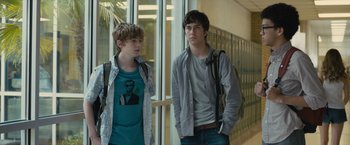 Movie still from “Paper Towns” (2015), directed by Jake Schreier – Two young men standing next to each other in front of lockers; Medium shot, Over the shoulder angle