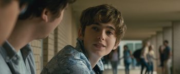 Movie still from “Paper Towns” (2015), directed by Jake Schreier – A young boy with a blue shirt is looking at the camera; Close Up shot, Over the shoulder angle
