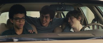 Movie still from “Paper Towns” (2015), directed by Jake Schreier – Two young men sitting in the back seat of a car; Medium shot, Over the shoulder angle