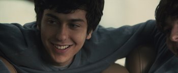 Movie still from “Paper Towns” (2015), directed by Jake Schreier – A young man smiling for the camera; Close Up shot, Over the shoulder angle