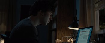 Movie still from “Paper Towns” (2015), directed by Jake Schreier – A young man is looking at a computer screen; Close Up shot, Low angle