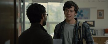Movie still from “Paper Towns” (2015), directed by Jake Schreier – Two men talking to each other in front of a window; Medium shot, Over the shoulder angle