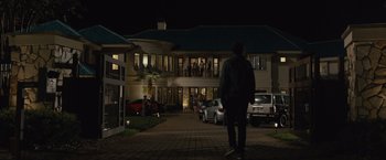 Movie still from “Paper Towns” (2015), directed by Jake Schreier – A man standing in front of a building at night; Extreme Wide shot, Over the shoulder angle
