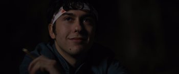 Movie still from “Paper Towns” (2015), directed by Jake Schreier – A man with a bandage around his head is smiling; Close Up shot, Low angle