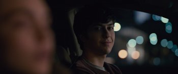 Movie still from “Paper Towns” (2015), directed by Jake Schreier – A man sitting in the back seat of a car at night; Close Up shot, Over the shoulder angle