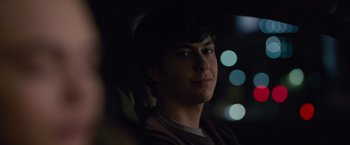 Movie still from “Paper Towns” (2015), directed by Jake Schreier – A man sitting in the back seat of a car at night; Close Up shot, Over the shoulder angle